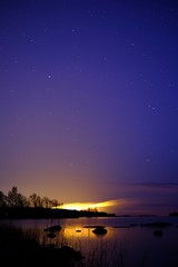 Fototapeta na wymiar Night city with a lake and a starry sky