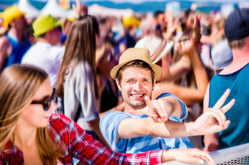 Fototapeta premium Teenagers at summer music festival enjoying themselves