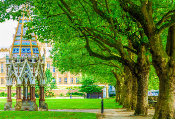 Palace of Westminster and Buxton Memorial Fountain in Victoria Tower Gardens in London