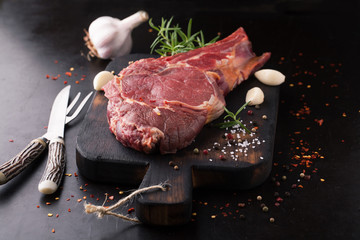 Raw beef steak with spices, garlic and rosemary
