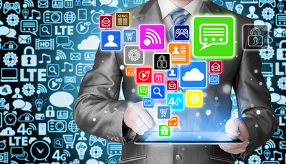 Obraz premium Business man using tablet PC with social media icon set