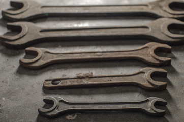 Old vintage wrenches tools on a gray plastic table.