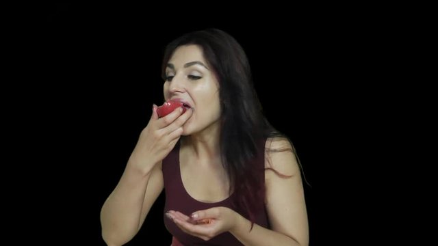 Woman Eats Tomato woman eating a fresh tomato healthy food, healthy lifestyle, alpha channel