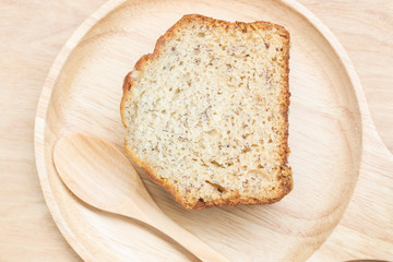 Sweet cake in wooden plate with spoon