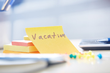 Vacation text on adhesive note