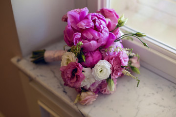 Rich bunch of pink peonies and lilac eustoma roses flowers