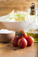 fresh lettuce salad with carrots cut into strips and whole tomatoes.