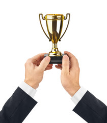 Golden trophy cup in hands