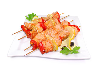Salmon kebab. Shashlik with roasted fish isolated on a white