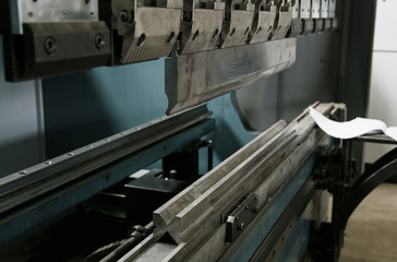 operator bending metal sheet by sheet bending machine