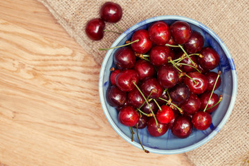 Fresh cherries berries in blue bowl