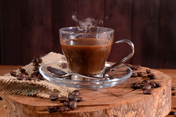 Glass cup of coffee on wooden slice