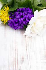 bouquet of colorful flowers on white wooden planks