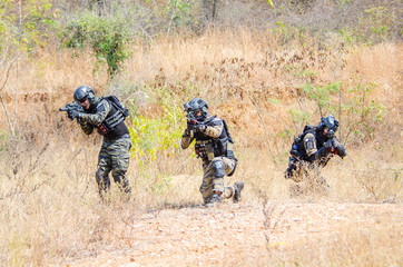 Portrait of men in action Airsoft gun.