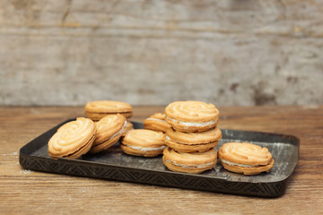 Delicious biscuits with cream on a vintage plate