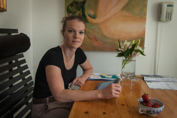 portrait of Miss sitting at a table with background images with