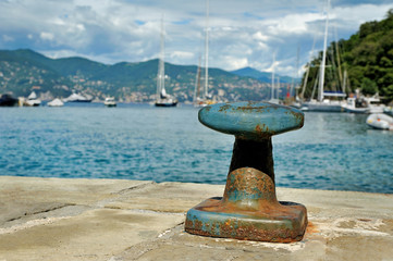 Mooring post in Portofino harbor with cloudly sky