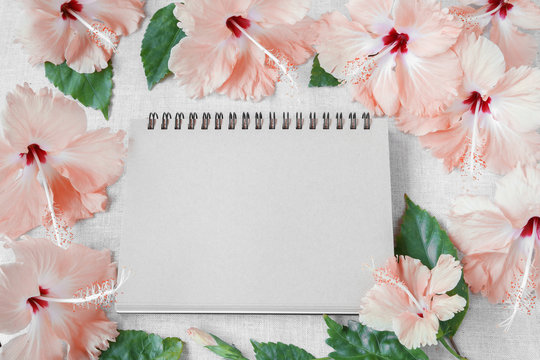 Notebook with pink Hibiscus flowers mock up background