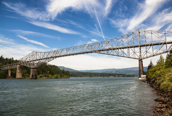 Bridge of the Gods, Columbia River, Oregon. Taken on a sunny day with clouds in the sky.