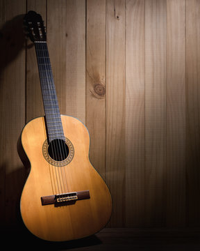 Classical guitar on wood background with copyspace.