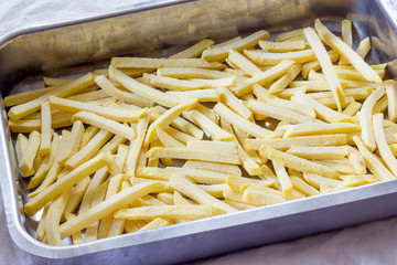 Baking pan of chips to be cooked in the oven