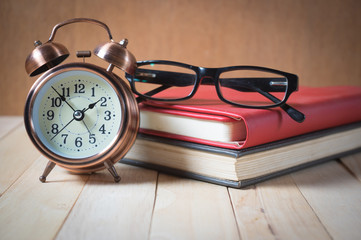 Retro alarm clock and book.