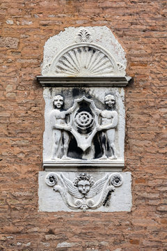 The coat of arms on the wall of the 15th-century Palazzo Molin the San Marco district of Venice, Italy, represents a mill wheel, the symbol the house of Molin.