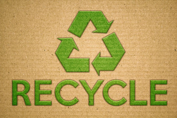 Recycle green symbol on cardboard with text recycle