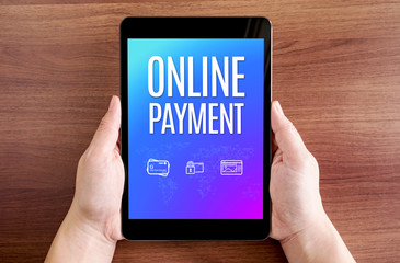 Two hand holding tablet with online payment and icon on screen a