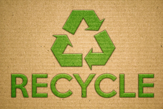Recycle green symbol on cardboard with text recycle