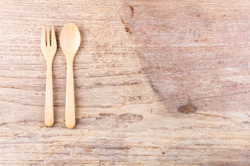 Wooden spoon and fork on wooden table background