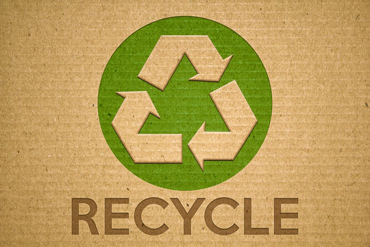 Recycle green symbol on cardboard with text recycle