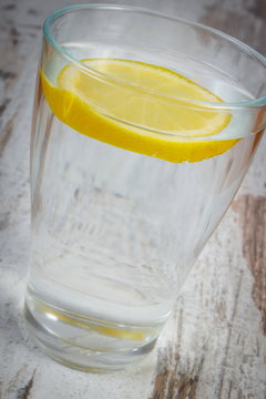 Glass of clean water with slice of lemon, cold lemonade