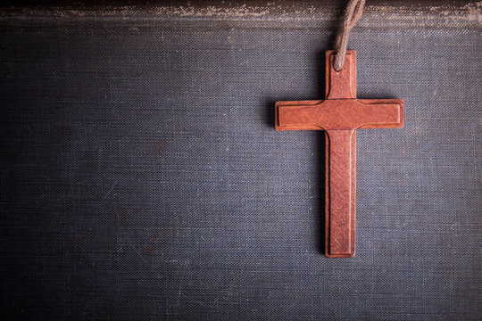 Image of wooden cross on bible background