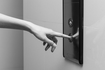 Pushing button. Close-up of female hand pushing button of elevat