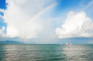 Rainbow over horizon of ocean beach