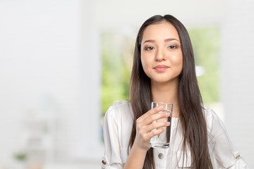 Smiling Young Woman with glass of Water