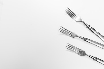 Old metal forks isolated on a white background.