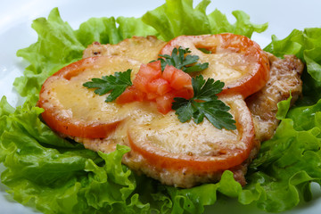 Pork baked with tomato and cheese