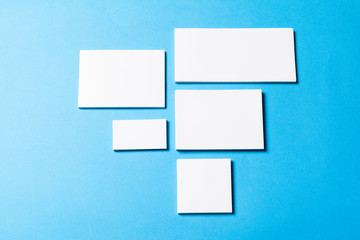 blank office objects organized for company presentation on blue paper background