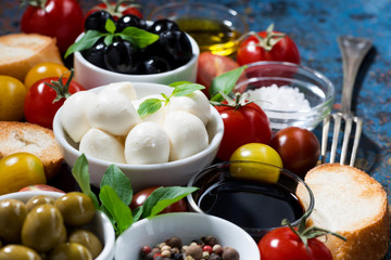 mozzarella, fresh ingredients for the salad and bread 
