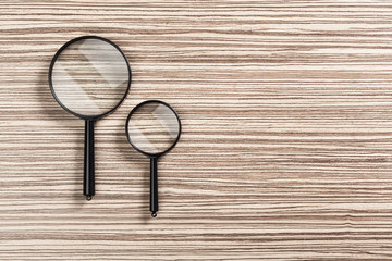 magnifying glass on the wooden background