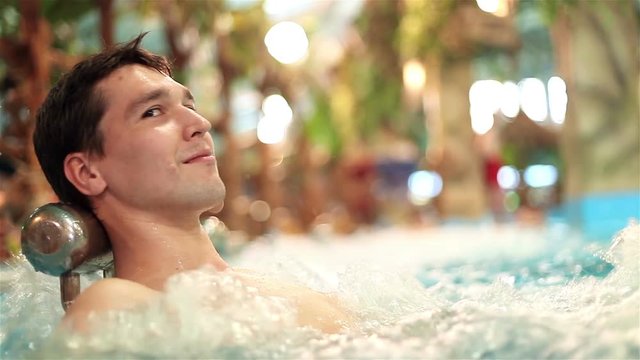 young man in a jacuzzi in water park