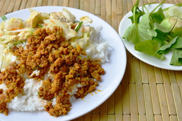 spicy minced pork yellow curry paste and stir fried cabbage with egg on rice