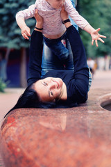 Happy mother and small daugher in a park