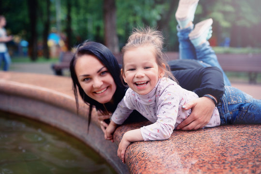 Happy mother and small daugher in a park