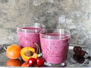the smoothies in a glass on a gray background