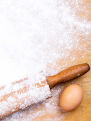 baking background with pastry board, rolling pin and egg