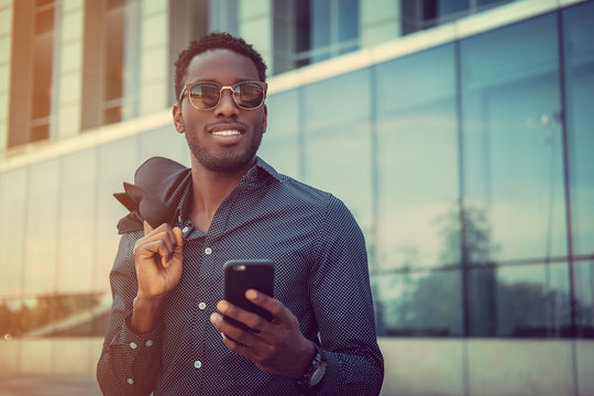  African american male using smartphone.