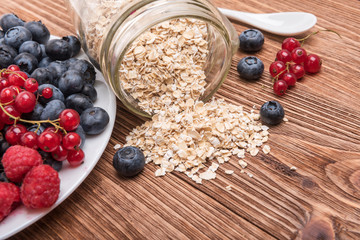 Smoothies with oatmeal ,berries in glass jars on a wooden background.